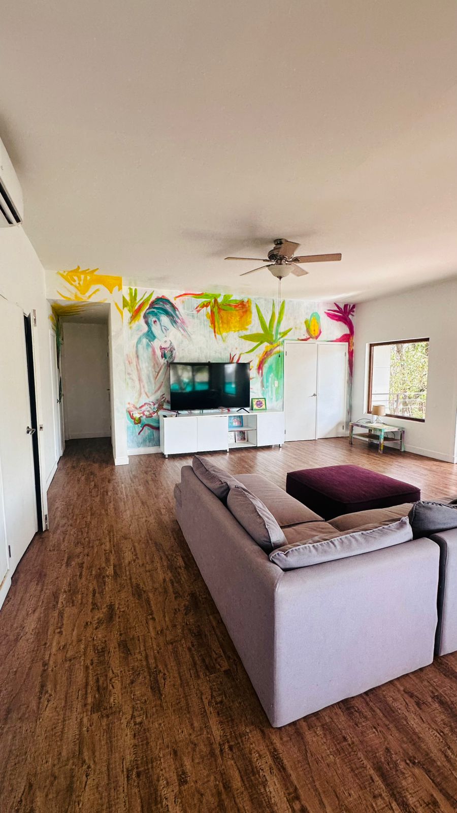 Striking living room with tropical mural artwork