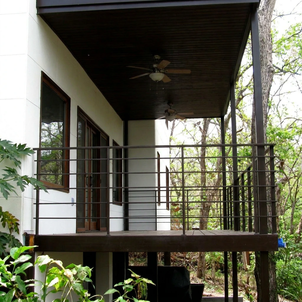 Covered terrace with ceiling fans overlooking the forest at Gemini Villas